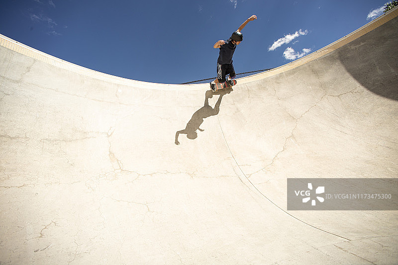 滑板手在深水泥碗中转弯图片素材