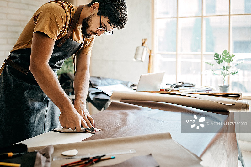 男人切割皮革图片素材