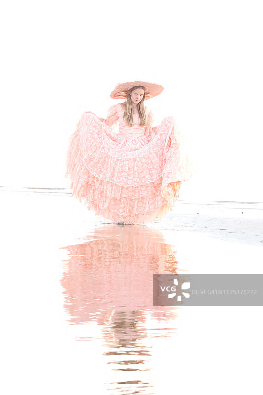 一位女士身穿大型桃色连衣裙，头戴配套帽子，背对阳光图片素材