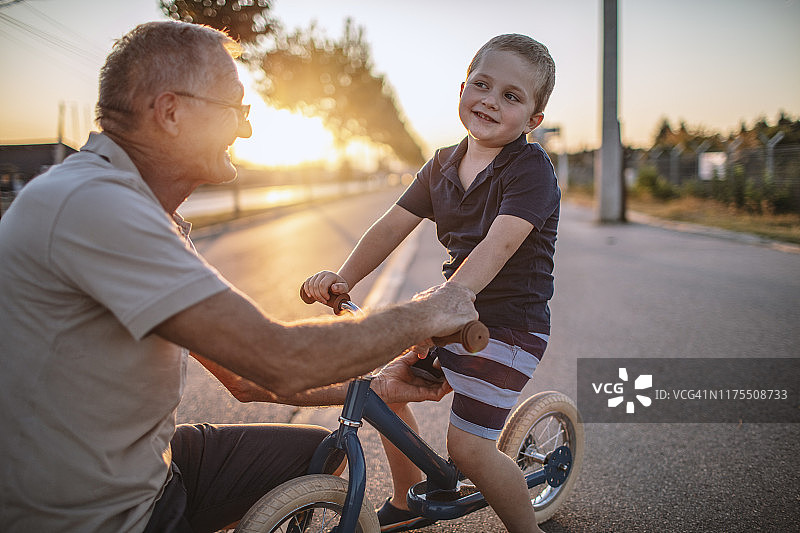 祖父教孙子骑自行车图片素材