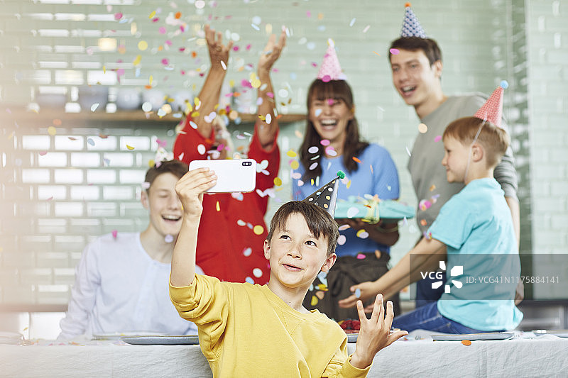 母子在厨房为奶奶庆祝生日，男孩自拍图片素材