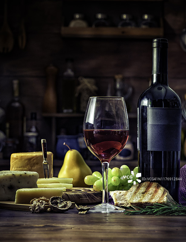 乡村木桌上的奶酪、火腿、萨拉米香肠和小吃图片素材