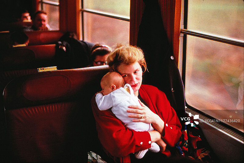 母亲在火车上抱着新生儿子图片素材