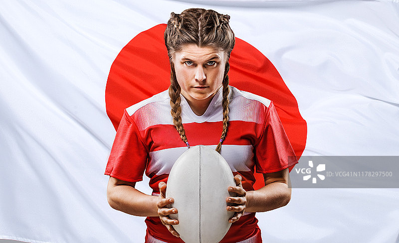 拿着球和日本国旗的费尔橄榄球运动员图片素材