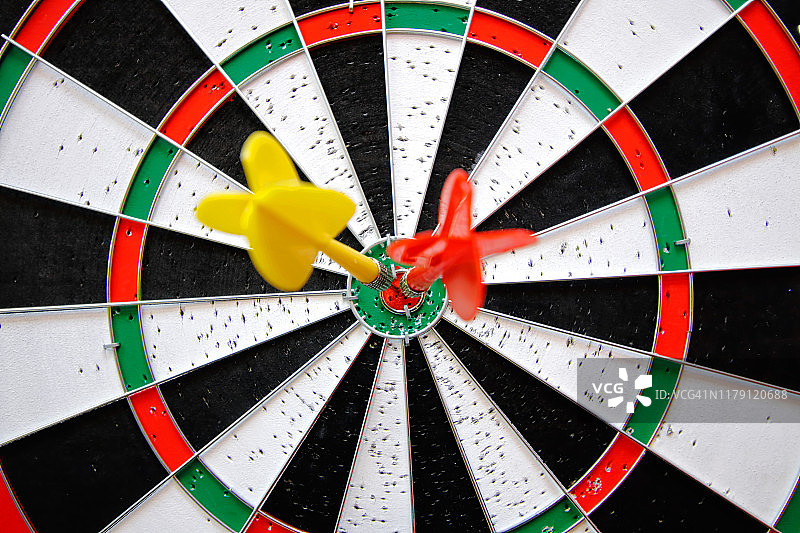 飞镖靶心的红色和黄色飞镖，商业目标概念图片素材