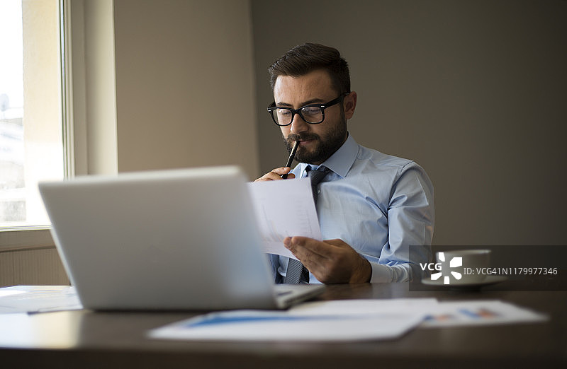 商人工作时拿着笔记本和文件图片素材