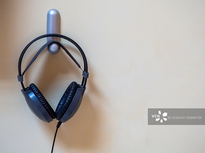 挂在墙上支架上的有线耳机图片素材