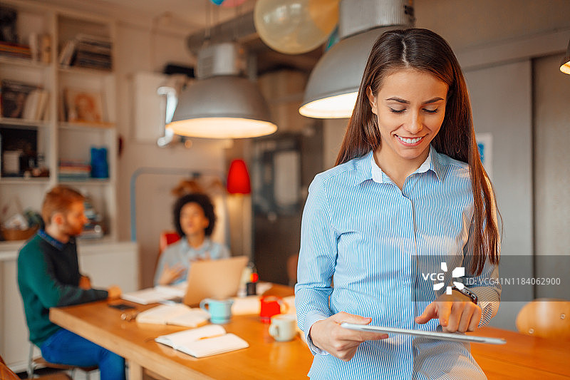 和同事一起工作，面带微笑的女人图片素材