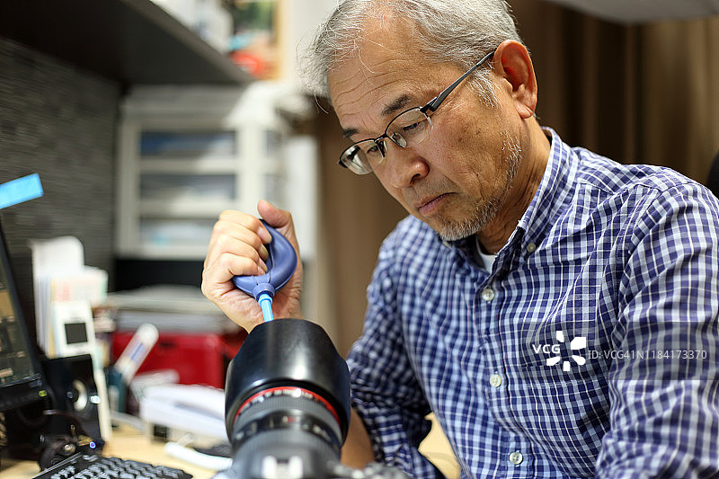男人清洁相机的肖像图片素材