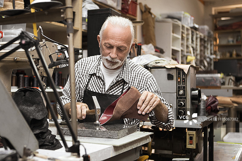 制鞋匠和缝纫机上未完成的鞋子图片素材