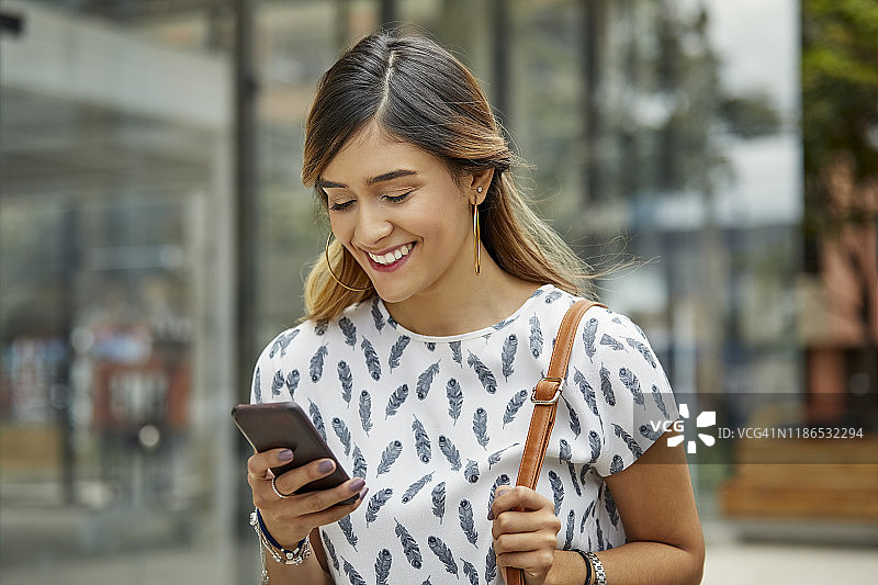 使用智能手机的微笑女商人图片素材