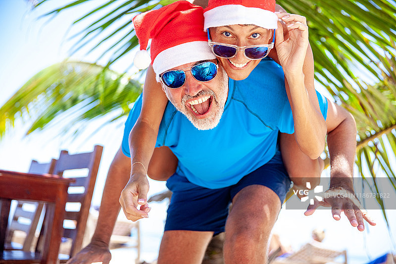 中年男人和妻子在海滩庆祝圣诞节图片素材