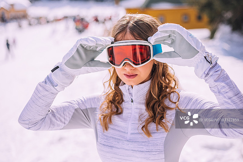 年轻女人整理她的滑雪镜图片素材