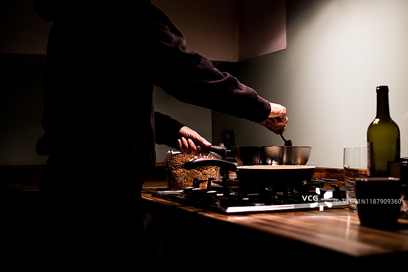 男子晚上在厨房做饭图片素材