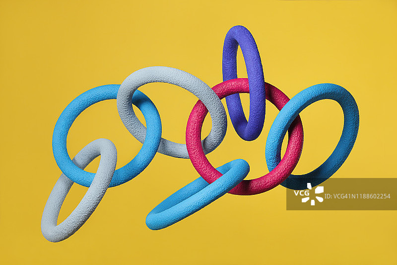 黄色背景上漂浮的抽象多色物体图片素材