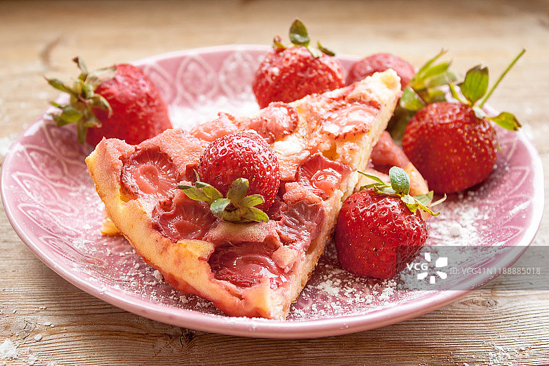 木桌背景上的草莓派和新鲜草莓切片图片素材