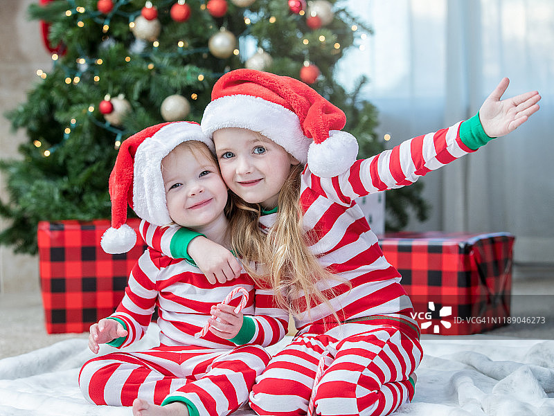 姐妹一起装饰圣诞树，准备迎接圣诞节图片素材
