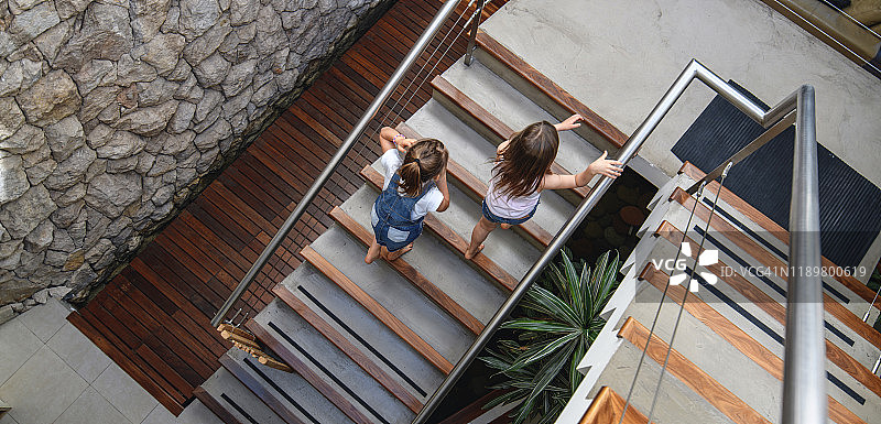 俯视在家爬楼梯的姐妹图片素材
