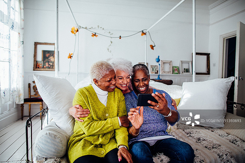 三名中年妇女在英国伦敦看智能手机图片素材