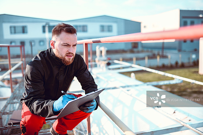 蹲着的男人检查油罐车状况图片素材