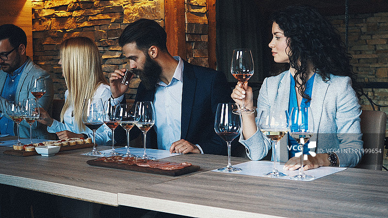 快乐的年轻朋友在地中海式晚宴上玩得开心并举杯祝酒图片素材