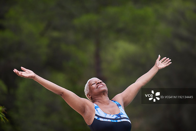 张开双臂的中年妇女肖像图片素材