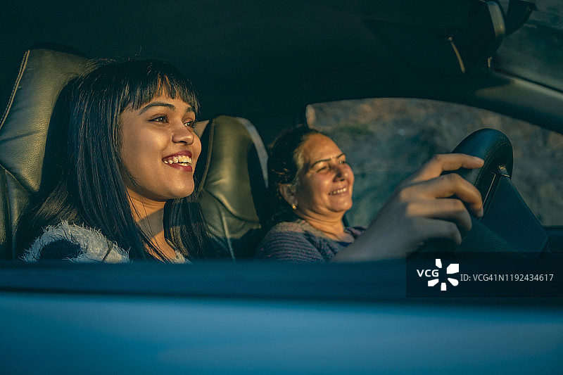 快乐年轻女人和母亲一起开车图片素材