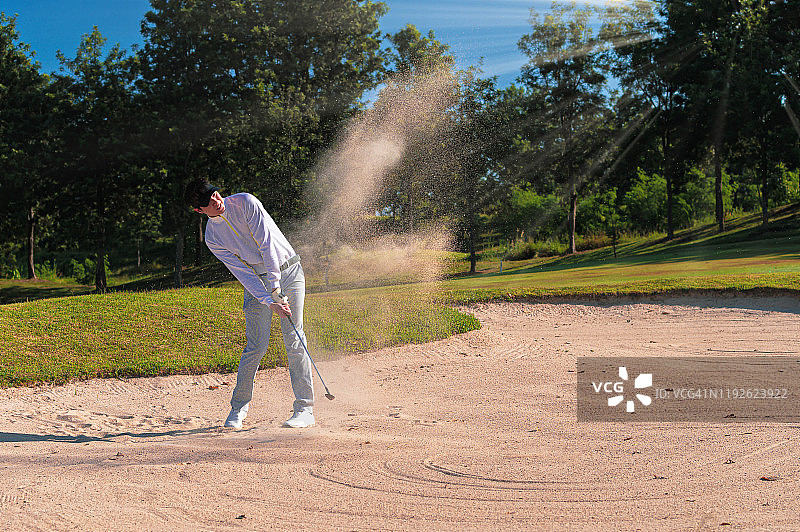 男子挥杆击球的模糊瞬间图片素材