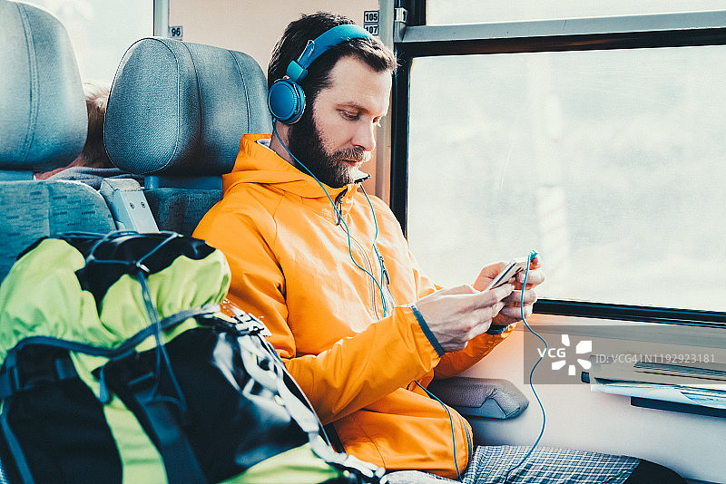 男游客在火车上听音乐图片素材