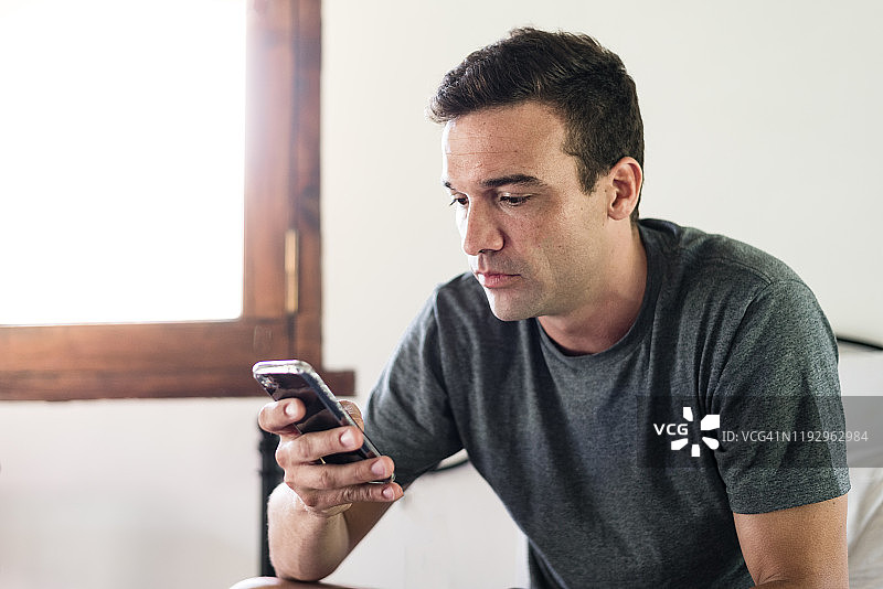 男子在智能手机上参加电话会议图片素材