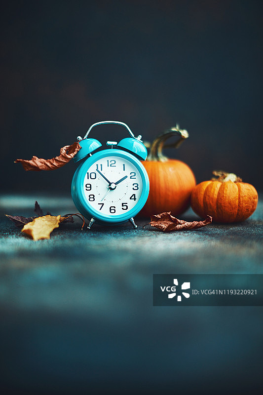 秋季时节：鸭色闹钟、树叶和南瓜图片素材