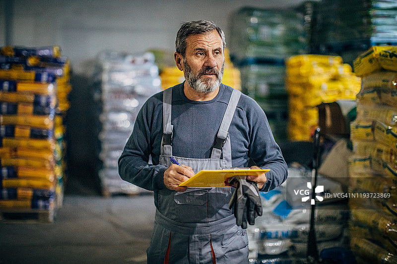 男人仓库经理在仓库中清点库存图片素材