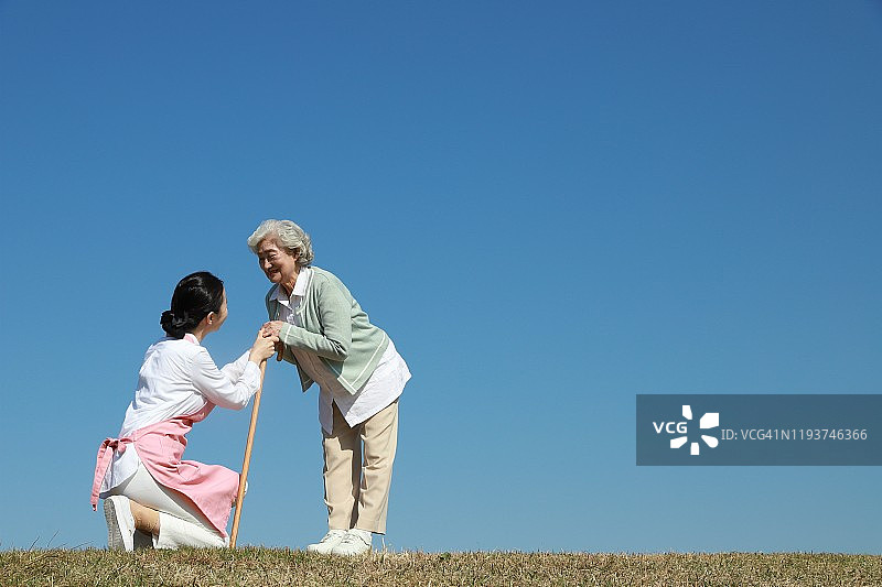 护士搀扶老年妇女使用手杖图片素材