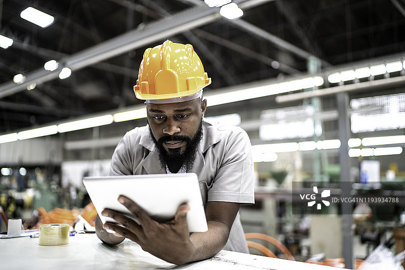男人在工厂里使用平板电脑图片素材