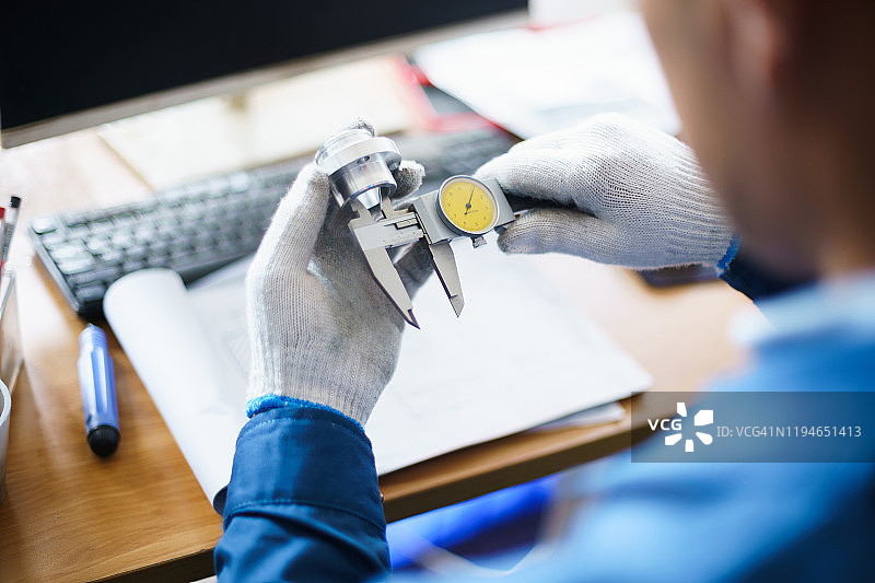 使用游标卡尺测量的亚洲工程师图片素材