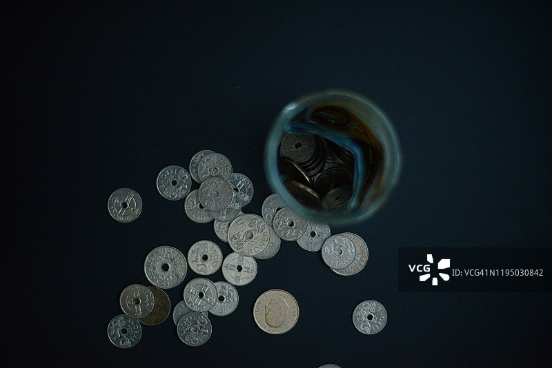 黑色背景下的硬币和纸币罐子图片素材