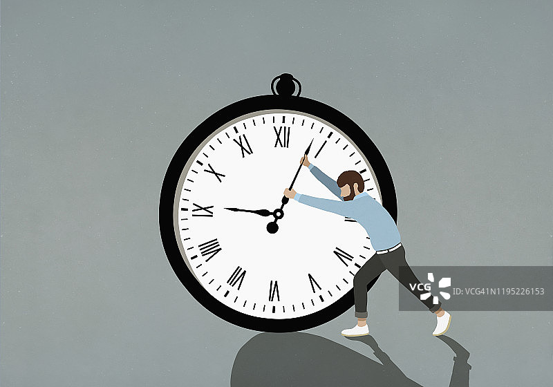男人推动大型秒表指针图片素材