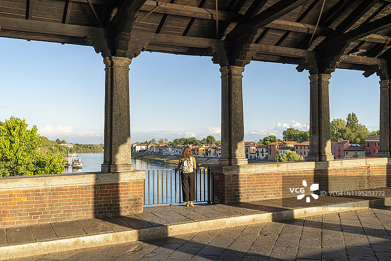 在意大利帕维亚的提契诺村老桥上眺望的女人图片素材