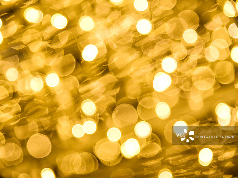 黄色/金色背景上的光晕和散景图片素材