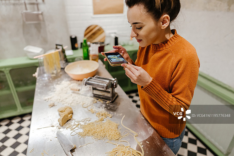 年轻女人拍摄自制意大利面图片素材