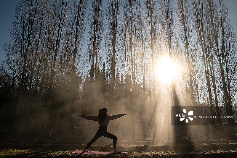 在雾蒙蒙的户外做瑜伽的成年女性照片图片素材