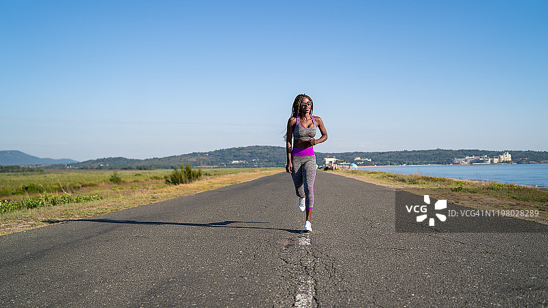 在海边跑步的非洲女人图片素材