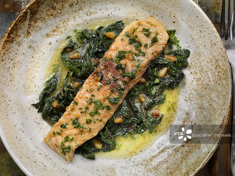 柠檬蒜香黄油浸鲑鱼配瑞士甜菜和烤松子图片素材