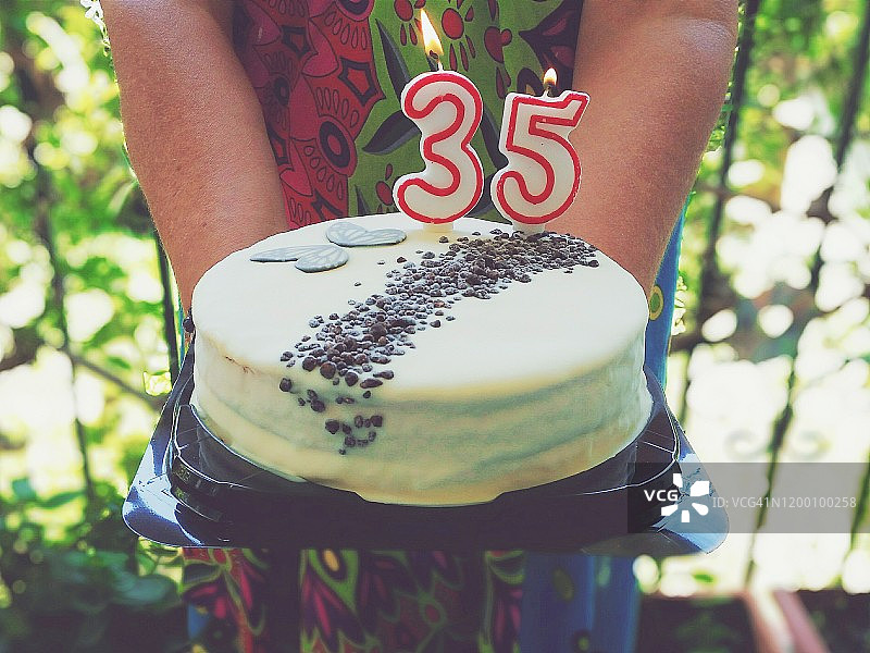 女人手捧35岁生日蛋糕图片素材