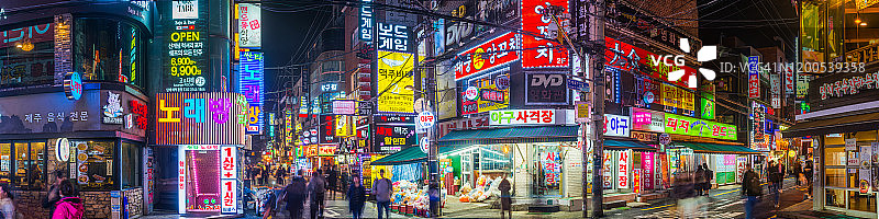 韩国首尔霓虹灯夜生活：色彩缤纷的购物街全景图片素材