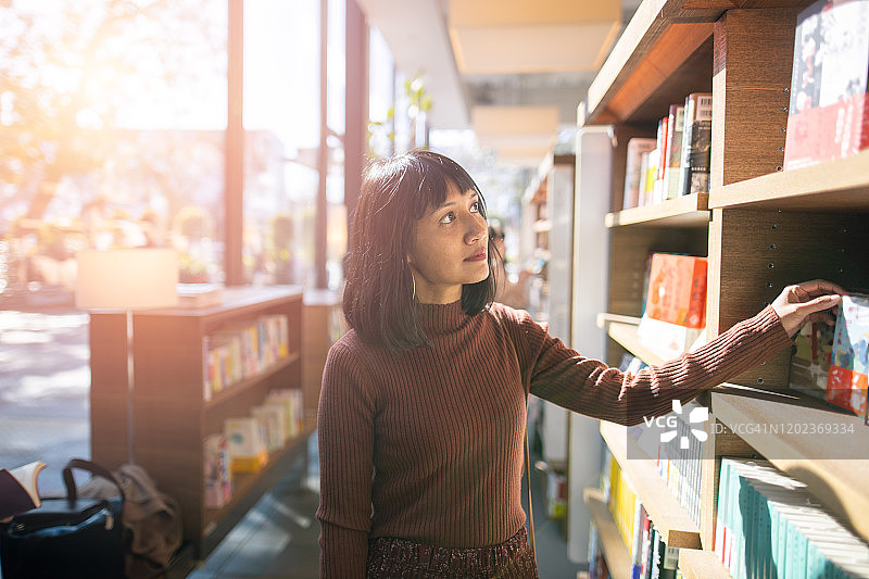 在图书馆找书的亚洲女性图片素材