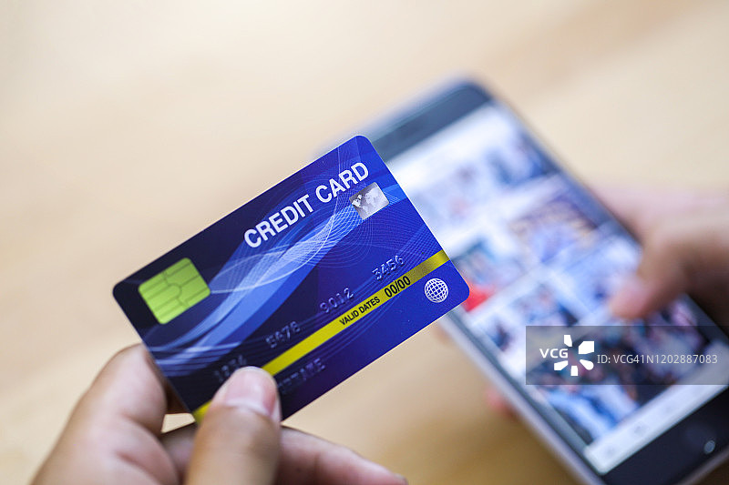 特写：年轻男子用手机在线购物图片素材