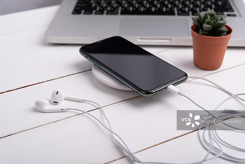 无线充电器上的智能手机空白屏幕图片素材