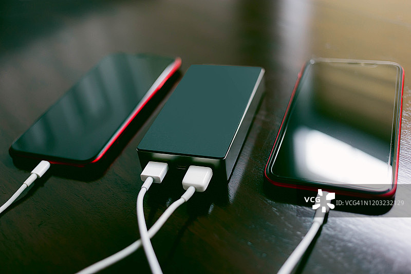 两部智能手机用充电宝共享充电图片素材