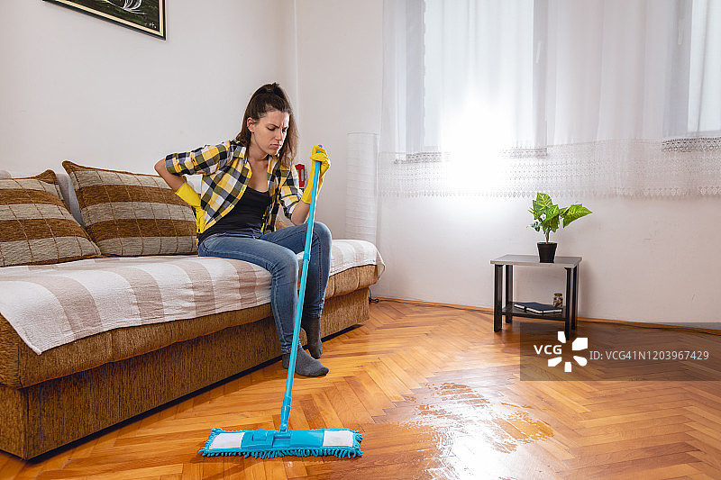 背痛的女子打扫卫生图片素材